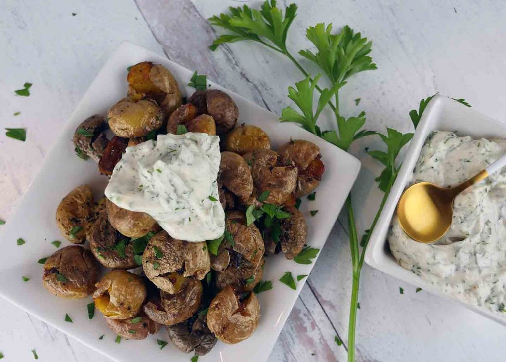 Crispy smashed potatoes with creamy dill sauce
