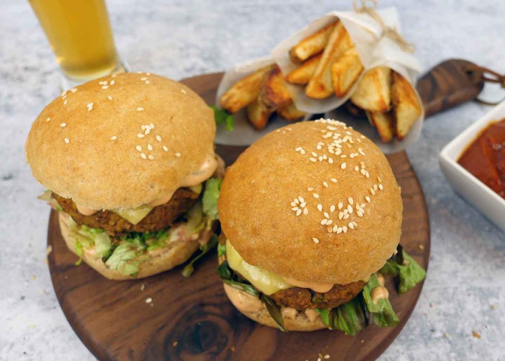 Beet and bean burgers with fries and a beer