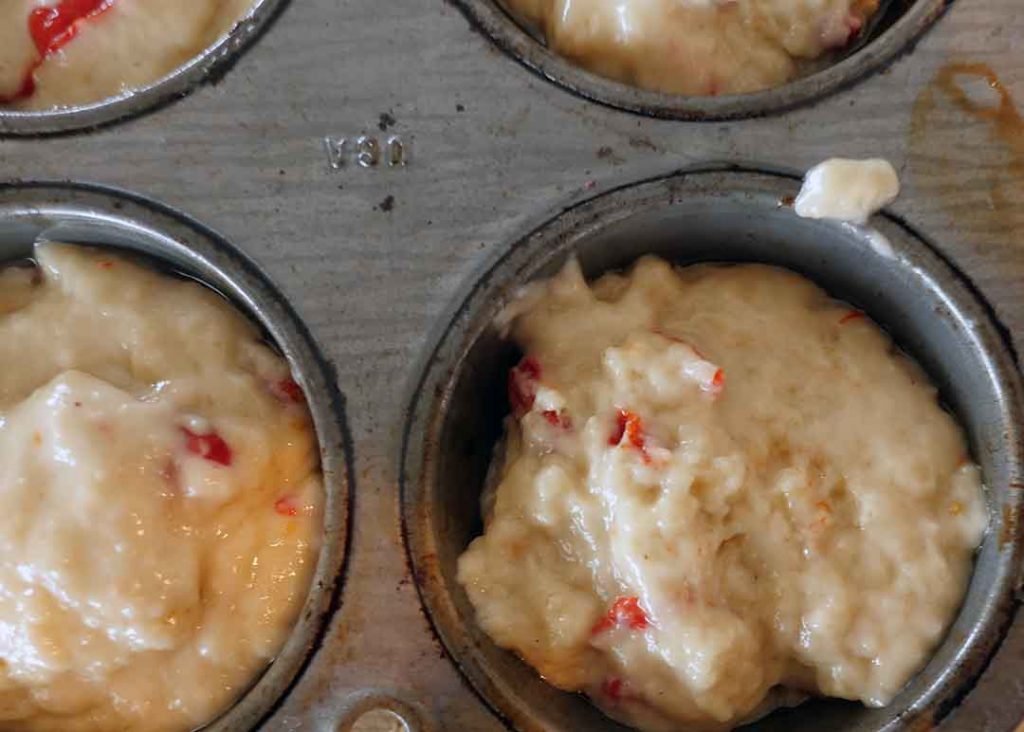 Goji berry muffin batter in muffin tins